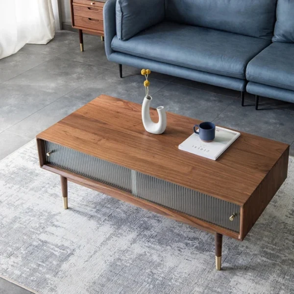 Nordic-Coffee-Table-600x600 Living room scene with walnut coffee table, fluted glass doors, brass-capped legs, blue sofa.