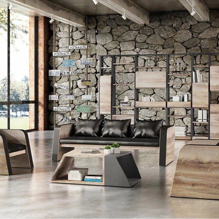 Oak sofa - 3 seater (3) Industrial-style office lounge scene with wood-grain sided 3-seater sofa and black cushions, paired with geometric coffee table and shelving in the background.