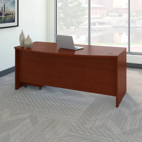Executive-Bow-Desk-Mahogany-600x600 Maghony-finish bow-front office desk staged by window with laptop and minimalist décor.