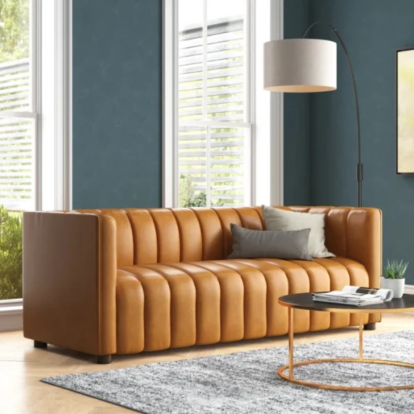 ANDERS-Sofa-Cammel-600x600 Angled view of upholstered sofa in a modern living room.
